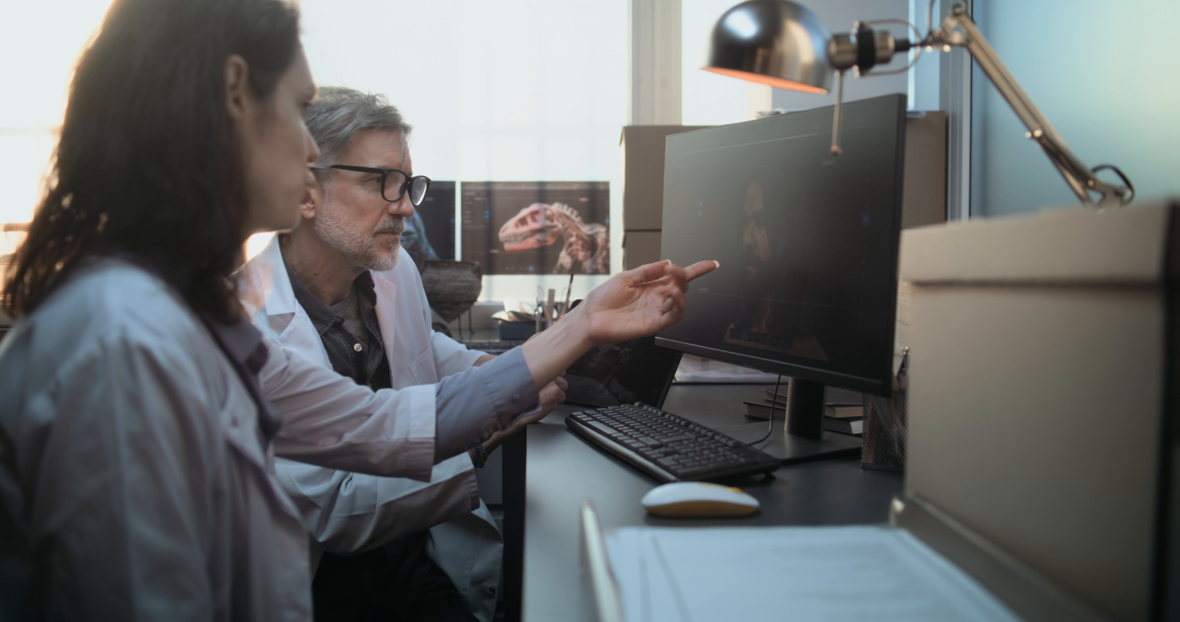 Two scientists reviewing results together at a workstation